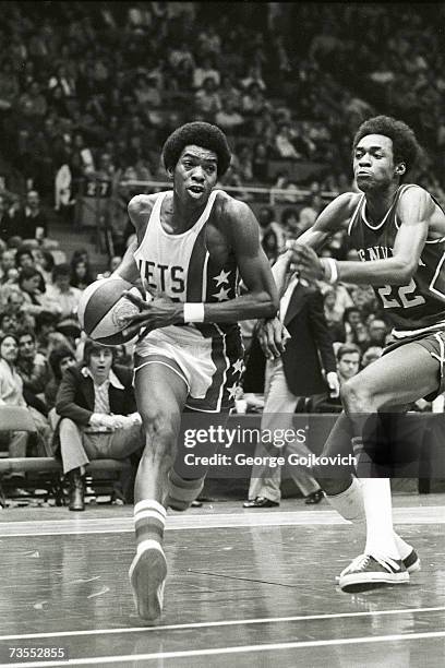 Forward Larry Kenon of the New York Nets drives against forward Mike Green of the Denver Nuggets during an American Basketball Association game at...
