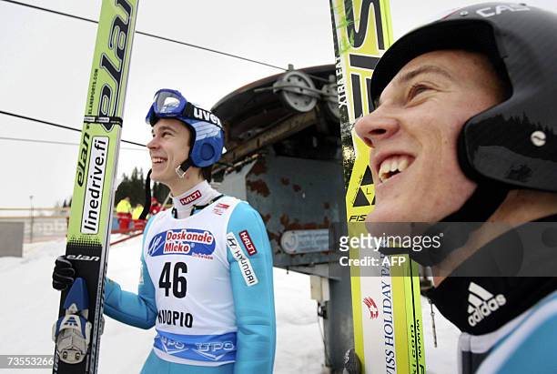 Arttu Lappi of Finland and Simon Ammann of Switzerland train for qualification for the FIS ski jumping World Cup and Nordic Tournament event in...
