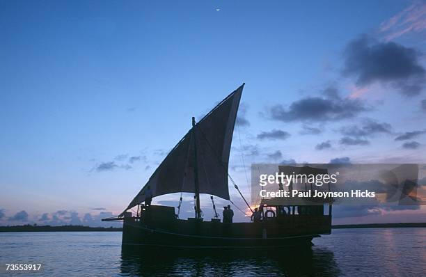 silhouette of a couple on a dhow at sunset - mombasa stock-fotos und bilder