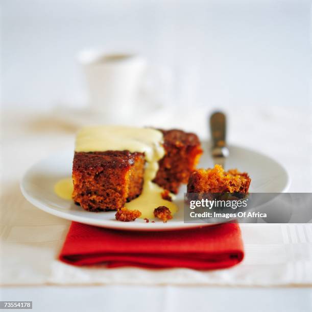 malva pudding with warm custard - malva pudding stock pictures, royalty-free photos & images