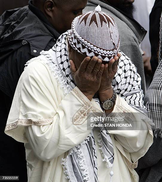 New York, UNITED STATES: A man is overcome by emotion outside the Islamic Cultural Center, 12 March 2007, in the Bronx borough of New York after a...