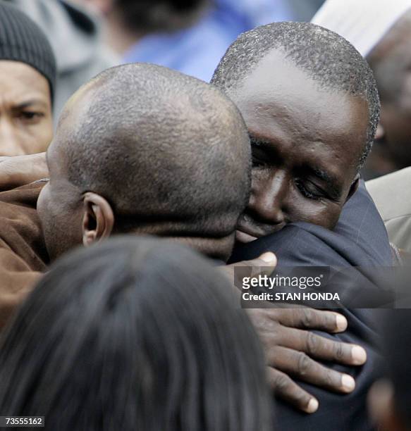 New York, UNITED STATES: Mamadou Soumare is consoled by a friend outside the Islamic Cultural Center, 12 March 2007, in the Bronx borough of New York...