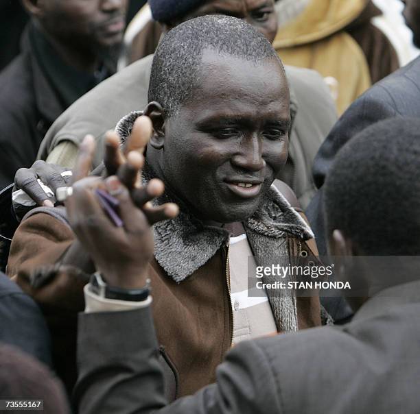New York, UNITED STATES: Mamadou Soumare is consoled by a friend outside the Islamic Cultural Center, 12 March 2007, in the Bronx borough of New York...