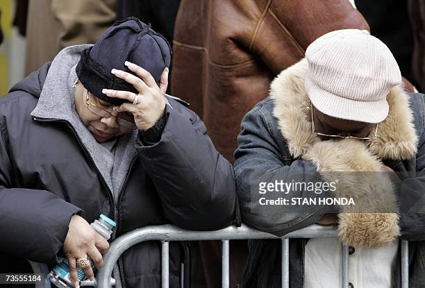 New York, UNITED STATES: Two neighborhood women greive outside the Islamic Cultural Center, 12 March 2007, in the Bronx borough of New York during a...