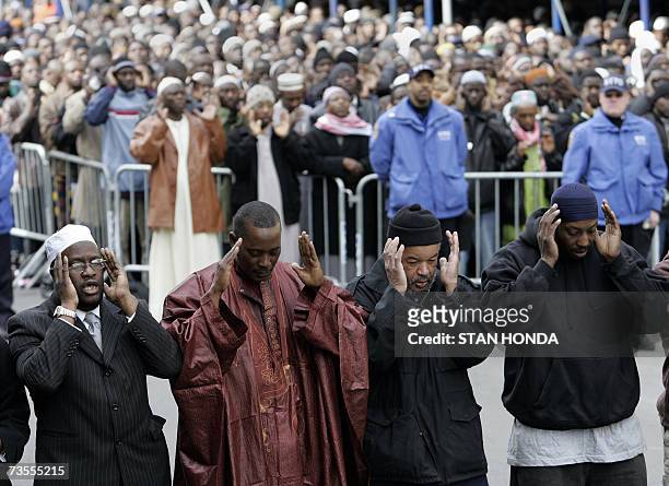 New York, UNITED STATES: Men pray outside the Islamic Cultural Center, 12 March 2007, in the Bronx borough of New York during a funeral for members...