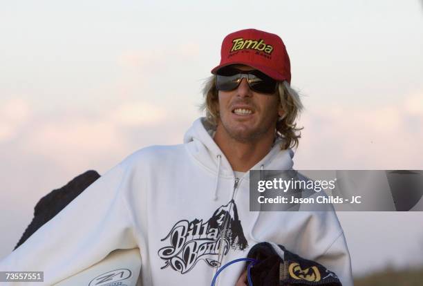 Three-times World Champion Andy Irons of the USA walks at sunrise along Keramas Beach July 21, 2006 in Bali, Indonesia.