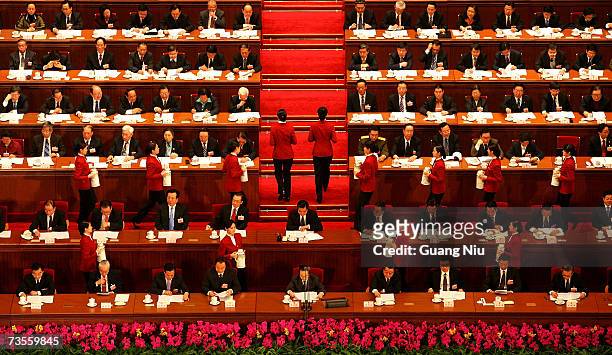 Attendant serves tea to Chinese leaders during the fourth plenary session of the National People's Congress, or parliament, at the Great Hall of the...
