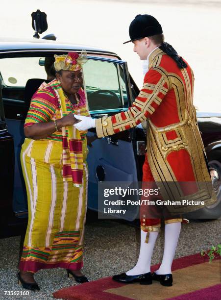 Mrs Theresa Kufuor, the President of the Republic of Ghana's wife, is helped by a footman as she arrives at the Horse Guards Parade for the start of...