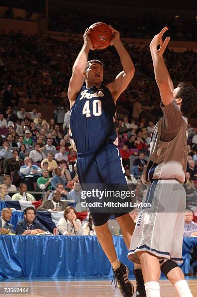 Luke Zeller of the Notre Dame Fighting Irish shoots against Jeremiah Rivers of the Georgetown Hoyas in the Big East College Basketball Tournament...