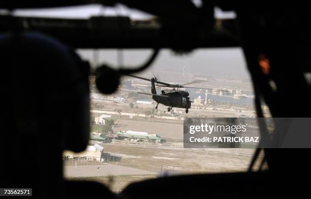 Army Blackhawk helicopter flies over former Iraqi president Saddam Hussein's al-Salam palace, transformed into a US base dubbed Camp Victory, in...