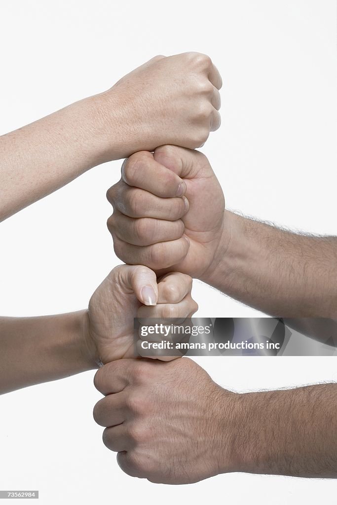 Woman and man stacking fists, close-up