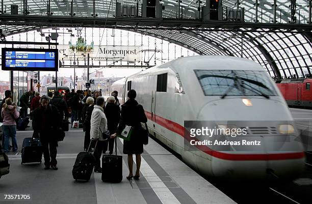 Travellers wait in front of an InterCityExpress at Berlin Central Station on 6 February 2007 in Berlin, Germany. Germany is currently in a heated...