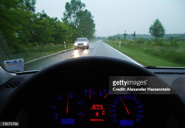Passing car on a wet street is seen out of a cockpit of another car on February 5, 2007 near Hanover, Germany. Germany is currently in a heated...