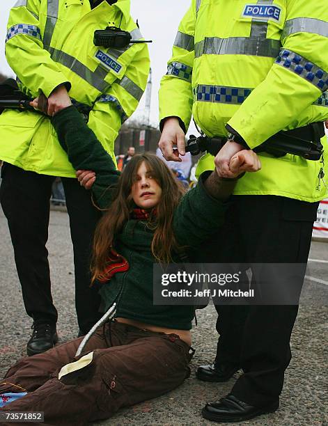 Campaigner is arrested during a protest at the Faslane naval base on the Clyde, home of the Trident Submarine fleet, March 14, 2007 in Faslane,...