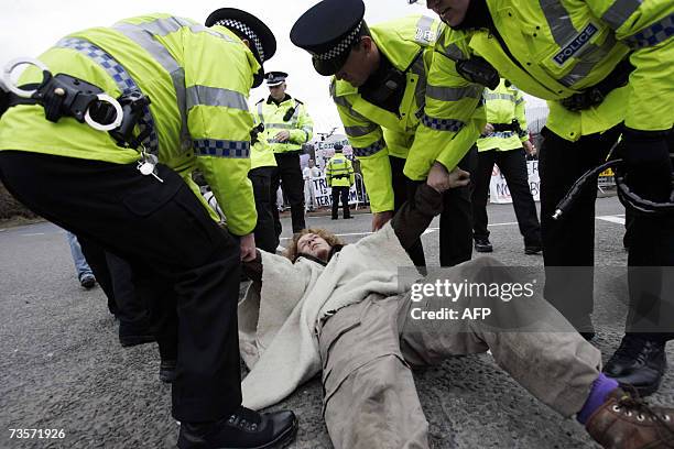 Faslane, UNITED KINGDOM: Campaigners stage a protest in front of the Trident submarine fleet naval base in Faslane, Scotland, 14 March 2007....