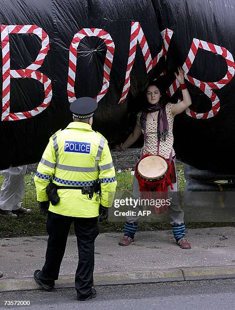 Faslane, UNITED KINGDOM: A campaigner holds an inflatable during a protest in front of the Trident submarine fleet naval base in Faslane, Scotland,...