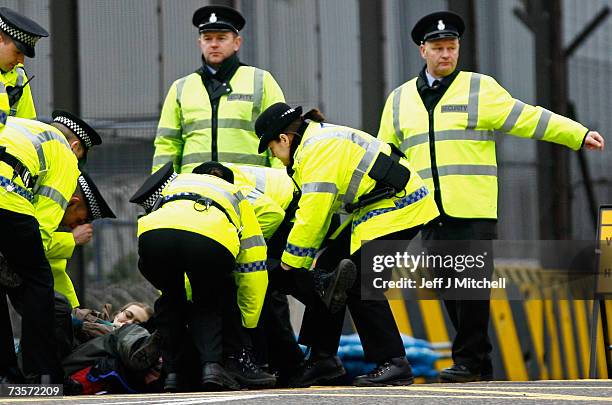 Campaigner is arrested during a protest at the Faslane naval base on the Clyde, home of the Trident Submarine fleet, March 14, 2007 in Faslane,...