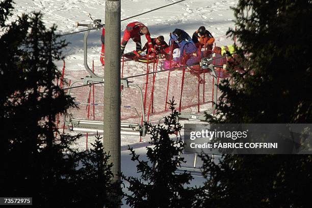 Lenzerheide, SWITZERLAND: Swiss Bruno Kernen is carried away after crashing during the men's downhill at the Alpine Ski World Cup finals in...