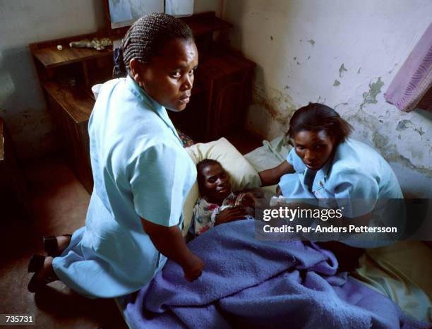 Nurses from South Coast Hospice care for a woman dying of Aids November 16, 1999 in Murchison in Southern Natal, South Africa. The hospice personnel...