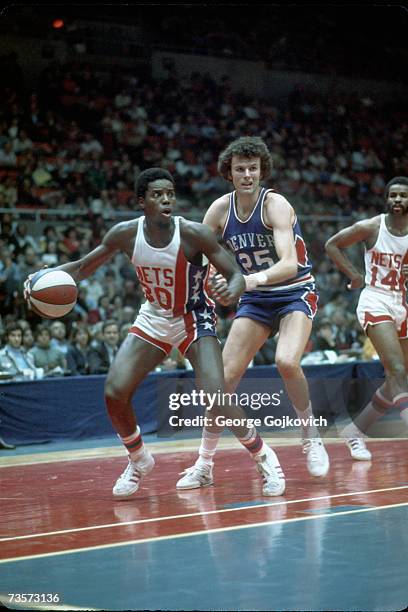 Guard Al Skinner of the New York Nets in action against forward Dave Robisch of the Denver Nuggets as guard Brian Taylor watches during an American...