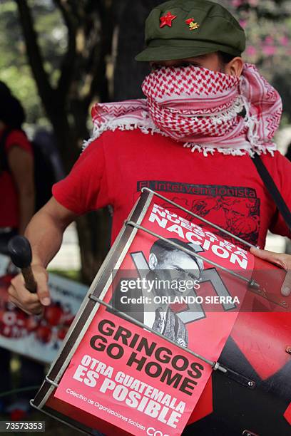 Member of a social organization protests with a bass drum in front of the US embassy in Guatemala City, 03 March 2007. US President George W. Bush...