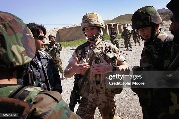 British Marine Robert Millman from Forres, Scotland, advises Afghan Army soldiers during a patrol March 14, 2007 in Kajaki, Helmand province,...