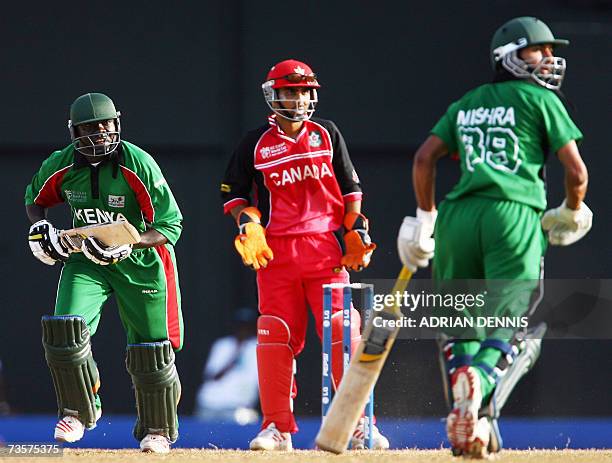 Gros Islet, SAINT LUCIA: Kenya's Captain Steve Tikolo runs down the wicket while Canada's Ashish Bagai and Kenya's Tanmay Mishra watch the ball...