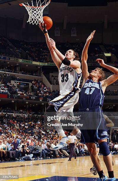 Mike Miller of the Memphis Grizzlies takes the ball to the basket against Andrei Kirilenko of the Utah Jazz during the game at FedExForum on February...