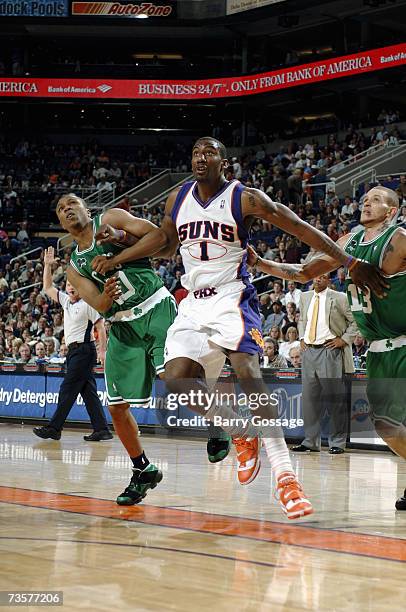 Amare Stoudemire of the Phoenix Suns fights for position against Sebastian Telfair and Delonte West of the Boston Celtics at US Airways Center on...