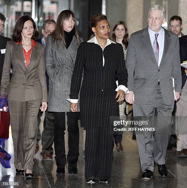 Chicago, UNITED STATES: Deposed media tycoon Conrad Black walks out of the US District Federal courthouse with daughter Alana , wife Barbara Amiel...