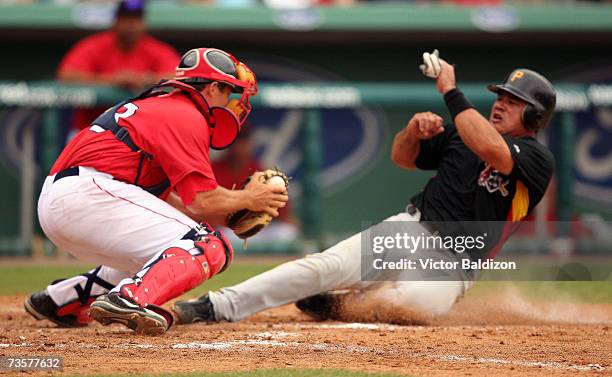 Einar Diaz of the Pittsburgh Pirates is tag out at the plate by catcher Kevin Cash of the Boston Red Sox during a Spring Training game on March 14,...