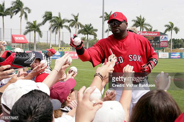 David Ortiz of the Boston Red Sox sign autographs before the game against the Pittsburgh Pirates during a Spring Training game on March 14, 2007 at...