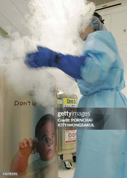 Thai officer collects stem cells from a tank during the stem cells process at Stem Life Company in Bangkok, 01 March 2007. Thai parents often mark...