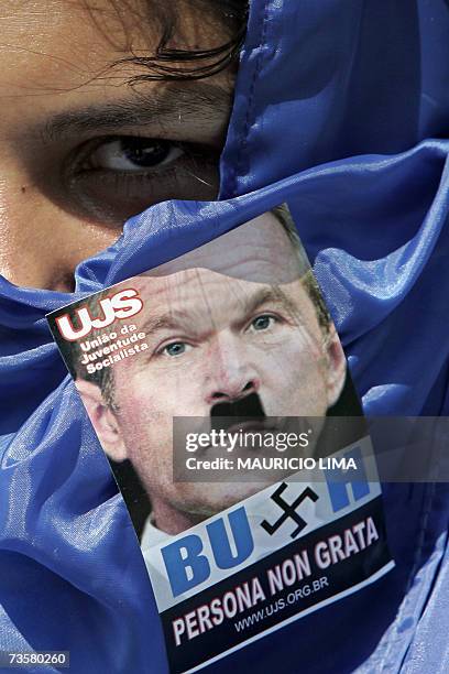 Student carries a sticker depicting US President George W. Bush as Adolph Hitler, during a protest in Sao Paulo, Brazil, 09 March 2007. US President...