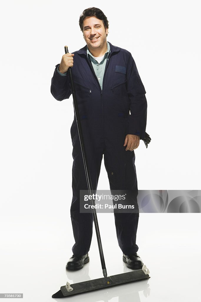 Janitor with broom on white background, portrait