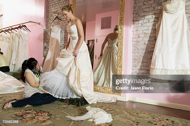 young woman having wedding dress fitted - jason florio stockfoto's en -beelden