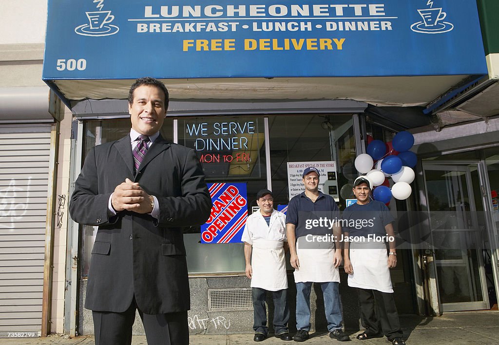 Businessman and staff outside of caf?, smiling, portrait