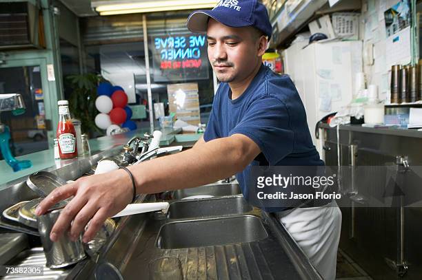 man working in cafe kitchen - jason florio stockfoto's en -beelden