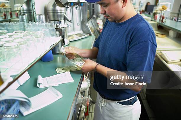 man checking caf? receipts - jason florio stockfoto's en -beelden
