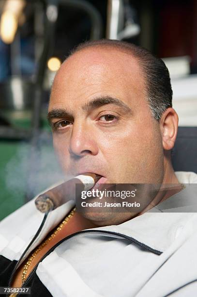 man smoking cigar, portrait - jason florio stockfoto's en -beelden