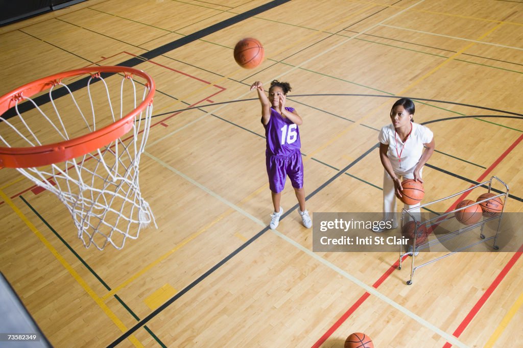 Coach By Teenage Girl Shooting Basketball High-Res Stock Photo - Getty