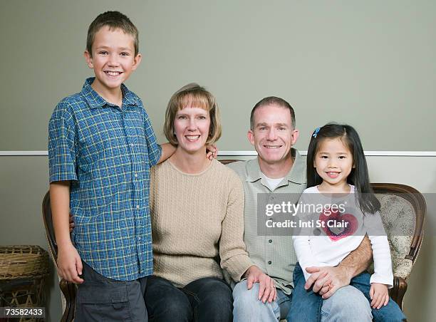 family with two children (4-9), portrait - adopted chinese daughter stock pictures, royalty-free photos & images