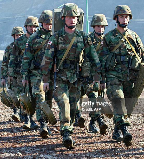File photo taken 12 December 2006 shows Georgian soldiers during military exercises at the Osiauri range, some 20 kms from the South Ossetian border....