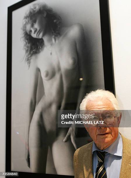 English photographer David Hamilton stands in front of one of his photographs taken in the late seventies at an exhibition of his work in Stuttgart...