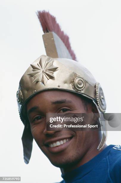 English footballer and midfielder with Liverpool, Paul Ince pictured wearing a Roman legionaries helmet during training with the England national...