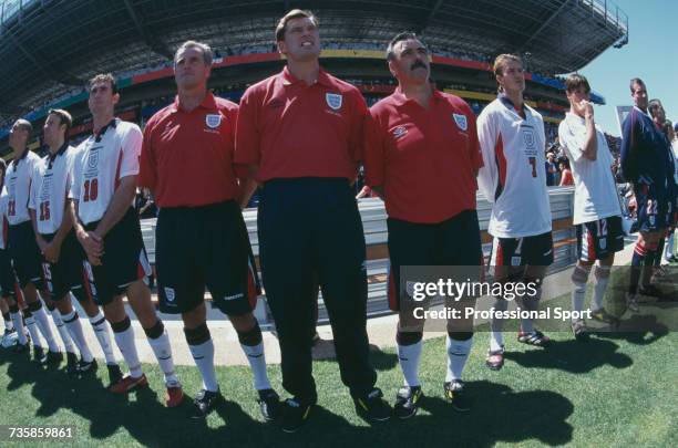 View of members of the England national football team, with manager Glenn Hoddle pictured in centre, standing for the anthems prior to the start of...