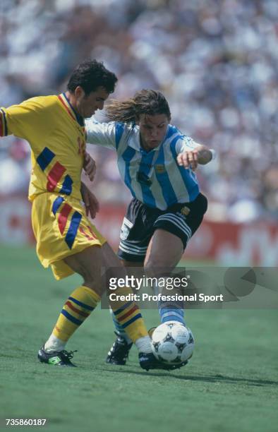 Argentine midfielder Fernando Redondo clashes with Romanian captain Gheorghe Hagi for the ball in the 1994 FIFA World Cup knockout stage round of 16...