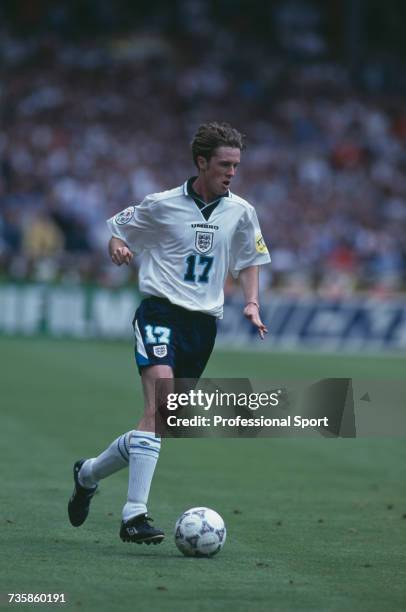 English footballer and midfielder with England, Steve McManaman pictured making a run with the ball in a game during the UEFA Euro 1996 European...