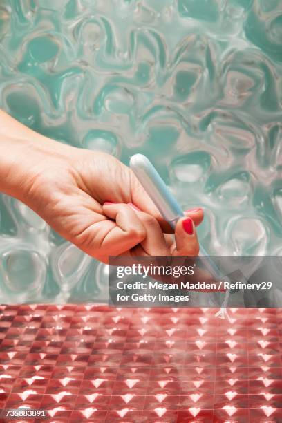 young wiman holding tampon - tampon stock pictures, royalty-free photos & images