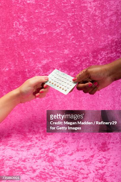 two young women holding birth control pills - birth control stock-fotos und bilder